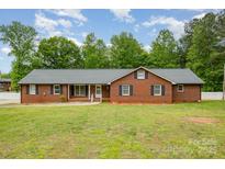 Charming single-story brick home featuring a well-manicured lawn and classic black shutters at 1376 Garland Ln, Lincolnton, NC 28092