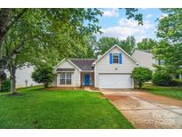 Charming single Gathering home with a well-manicured lawn and a welcoming blue front door at 1863 New Castle Dr, Fort Mill, SC 29707