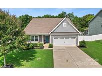 Charming single Gathering home with well-manicured lawn and attached two-car garage at 2124 Katie Alice Cir, Waxhaw, NC 28173