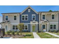Charming townhome with blue siding, white trim, and a vibrant green front door at 3015 Howell Mill Rd, Charlotte, NC 28208