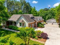 Beautiful home with well-manicured landscaping, a circular driveway, and a detached three-car garage at 4307 Edgeland Rd, Edgemoor, SC 29712