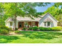 Charming single-story home with lush lawn, mature trees and a covered brick porch at 4307 Edgeland Rd, Edgemoor, SC 29712