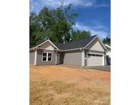 Charming single story home features gray siding, white trim, and an attached two car garage at 503 Eddleman Rd, Kannapolis, NC 28083
