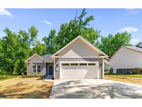 Charming single-Gathering home featuring a two-car garage and freshly laid lawn with blue sky at 503 Eddleman Rd, Kannapolis, NC 28083