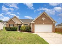 Charming brick and siding home with a well-manicured lawn and attached two-car garage at 6849 Blake Brook Dr, Concord, NC 28025