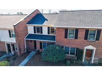 Brick townhome featuring black shutters, gray roof and small front yard at 825 21St Ne Ave, Hickory, NC 28601