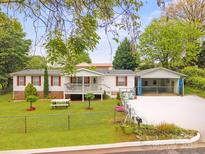 Charming one-story home with red shutters, front porch and fenced yard on a landscaped lot at 1106 3Rd Sw Ave, Hickory, NC 28602