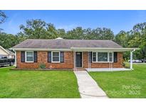 Charming brick ranch-style home with a well-manicured front yard and inviting covered porch at 1204 Glenarden Dr, Rock Hill, SC 29730