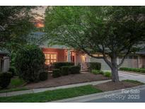 Charming exterior with well-manicured landscaping, inviting porch, and attached two-car garage at 142 Aztec Cir, Mooresville, NC 28117