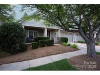 Charming home featuring a beautifully landscaped front yard with mature trees and inviting curb appeal at 142 Aztec Cir, Mooresville, NC 28117