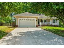 Charming single-story home featuring a two-car garage and inviting front porch at 185 Hunters Point Dr, Rockwell, NC 28138