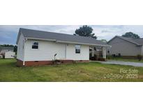 Charming single-story home featuring white siding, gray roof, and a well-maintained lawn at 2109 Boggs St, Lincolnton, NC 28092