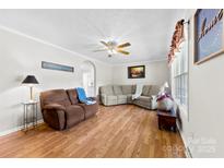 Comfortable living room with hardwood floors, ceiling fan, neutral paint, and cozy seating at 300 Scotland Dr, Kings Mountain, NC 28086