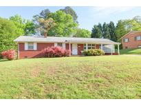 Charming brick home featuring a well-maintained lawn and colorful landscaping at 3119 6Th Sw Ave, Hickory, NC 28602