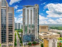 Modern high rise building with glass windows, balconies, and surrounding city views on a sunny day at 333 W Trade St # 800, Charlotte, NC 28202