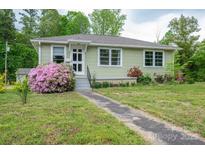 Charming single-story home with lovely landscaping, flowering bushes and a concrete walkway at 400 Houser St, Cherryville, NC 28021