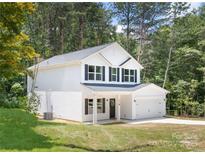 Charming two-story home boasts a classic design, manicured lawn, and an attached two-car garage at 601 Westway Dr, Gastonia, NC 28054