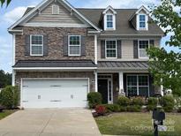 Charming two-story home with stone accents, manicured landscaping, and a two-car garage at 79044 Ridgehaven Rd, Lancaster, SC 29720