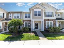 Charming townhouse showcasing a stone facade and well-manicured landscaping at 827 Gentlewinds Ct, Fort Mill, SC 29708