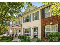 Charming townhouse with blue shutters, landscaping, and a well-maintained front yard at 8814 Gerren Ct, Charlotte, NC 28217