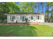 Charming single-story home with well-manicured lawn, flower boxes, and a welcoming front door at 1420 Columbus St, Albemarle, NC 28001