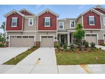 Charming townhome with red accents, a one-car garage, and a well-maintained front yard at 2009 Vinyasa Ln # Sts-44, Charlotte, NC 28215