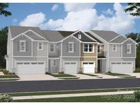 Charming townhome featuring double garage, grey siding and stone details in a vibrant, walkable community at 2009 Vinyasa Ln # Sts-44, Charlotte, NC 28215