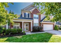 Charming two-story brick home with a well-manicured lawn and inviting front porch at 219 Pleasant Grove Ln, Mooresville, NC 28115