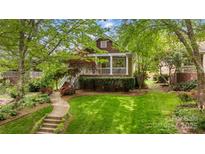 Charming home featuring a welcoming porch, landscaped yard, and beautiful curb appeal at 2306 Club Rd, Charlotte, NC 28205