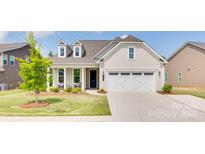 Charming single-Gathering home with a two-car garage, manicured lawn, and inviting front porch at 3029 Trace Meadow Ct, York, SC 29745