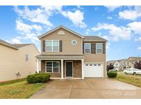 Charming two-story home with stone accents, a single-car garage, and a well-manicured front yard at 3033 Green Apple Dr, Dallas, NC 28034
