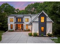 Stunning two-story home features a modern design, well-manicured landscaping, and a spacious driveway for easy parking at 3933 Ayrshire Pl, Charlotte, NC 28210