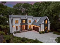 Beautiful two-story home with a spacious driveway, integrated garage, and manicured landscaping showcasing modern elegance at 3933 Ayrshire Pl, Charlotte, NC 28210