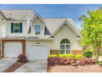 Charming townhome featuring a one-car garage, arched window, and beautifully landscaped front yard at 5206 Fire Water Ln, Fort Mill, SC 29707