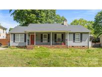 Charming one-story home with a welcoming front porch and a well-maintained lawn at 6915 Norchester Ct, Charlotte, NC 28227