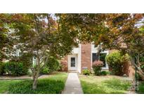Charming townhome with brick facade, mature trees, and well-maintained landscaping at 8326 Ramath Dr, Charlotte, NC 28211