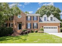 Charming brick two-story home with manicured lawn and attached two car garage in desirable neighborhood at 1468 Woodhurst Dr, Rock Hill, SC 29732