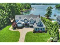 Stunning aerial view of home with waterfront access and manicured lawn, featuring a private dock and lush landscaping at 299 Barber Loop, Mooresville, NC 28117