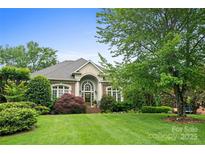 Beautiful brick home with a manicured lawn and a grand entrance, enhanced by lush landscaping at 3420 Maryhurst Ln, Charlotte, NC 28226