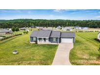 Beautiful single-story home with a two-car garage, manicured lawn, and inviting front porch at 3615 Kimber Ln, Sherrills Ford, NC 28673