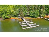 Expansive dock with gazebo offers waterfront living and access to serene lake surrounded by lush greenery at 6712 Cove Ln, Sherrills Ford, NC 28673
