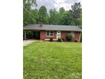 Charming one-story brick home featuring a carport, manicured lawn, and mature trees at 755 Victory Grove Church Rd, Lincolnton, NC 28092