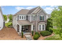 Charming two-story home with mixed brick and vinyl siding and well-maintained landscaping at 9802 Sky Vista Dr, Huntersville, NC 28078