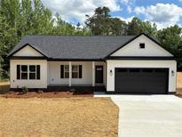 Charming white single-story home featuring a black garage door, matching shutters, and a well-manicured lawn at Lot 9 Lilly Pad Dr, Salisbury, NC 28146