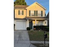 Charming two-story home features a front-facing garage and a welcoming front porch with dark green door and shutters at 1012 Kings Mountain Ln, Gastonia, NC 28054