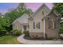 Charming home with brick and vinyl siding, landscaped front yard, and inviting entrance at 1033 Marguerite Dr, Lowell, NC 28098