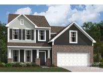 Charming two-story home featuring a two-car garage and inviting front porch at 1211 Fremont Dr, Wingate, NC 28174