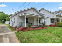 Charming bungalow with a covered front porch, swing, and well-maintained lawn at 18 Douglas Nw Ave, Concord, NC 28025