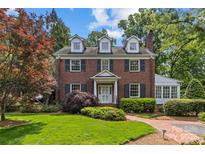 Charming brick home featuring classic architecture, dormer windows, and mature landscaping at 1949 S Wendover Rd, Charlotte, NC 28211