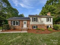 Charming brick home with manicured lawn, black shutters, and a welcoming front entrance at 269 Bud Black Rd, Crouse, NC 28033